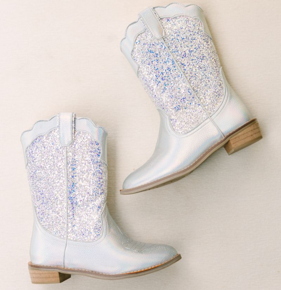 Pair of Wild and Rae's Disco Dreams boots on a beige background