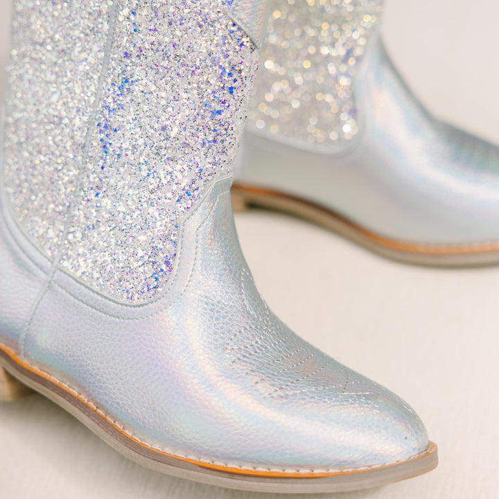Silver glittery boots on a light background