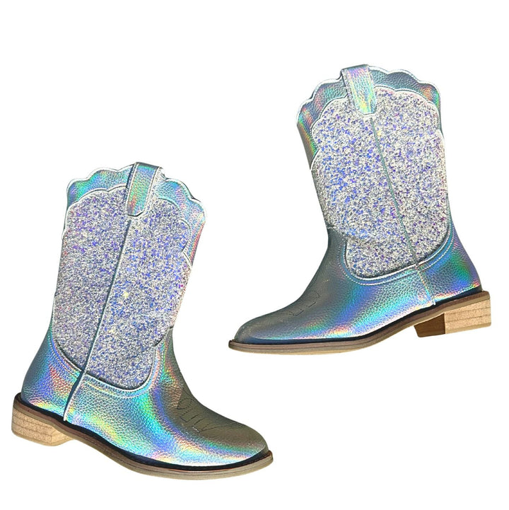 Pair of glittery silver wild + rae cowboy boots on a white background