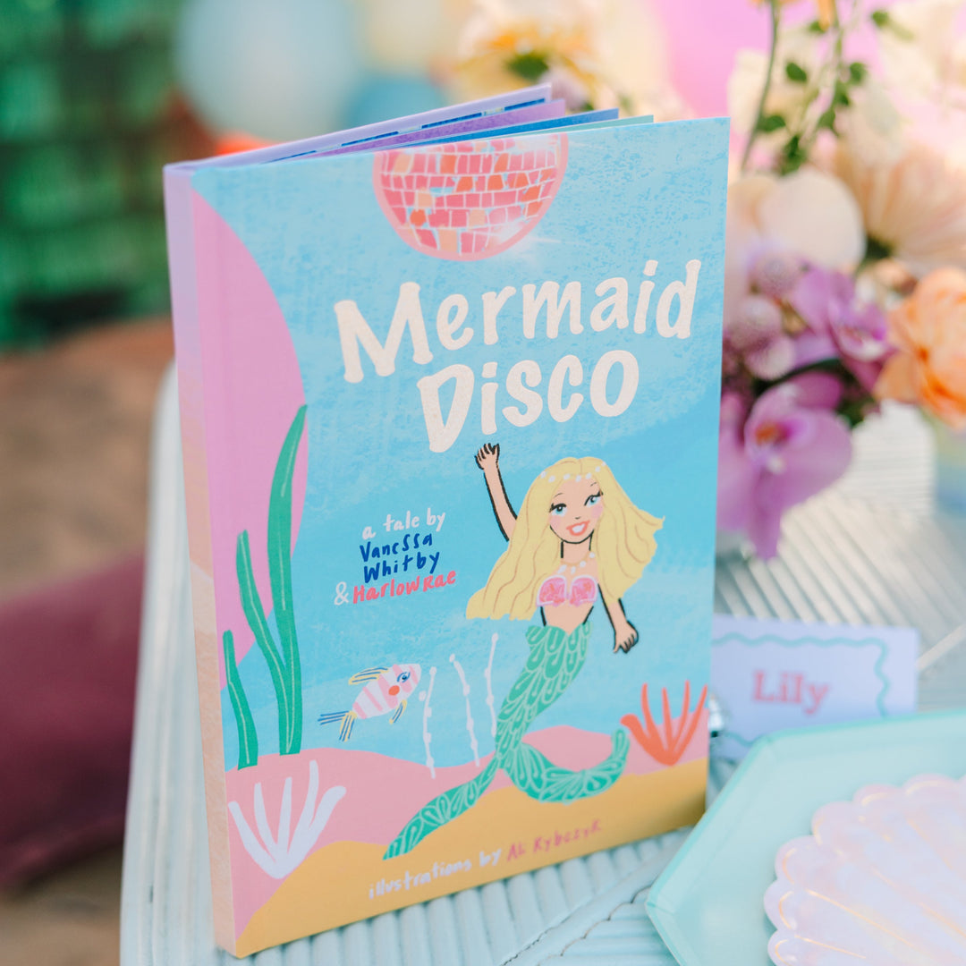 Children's book titled 'Mermaid Disco' with a mermaid illustration on a decorative surface.