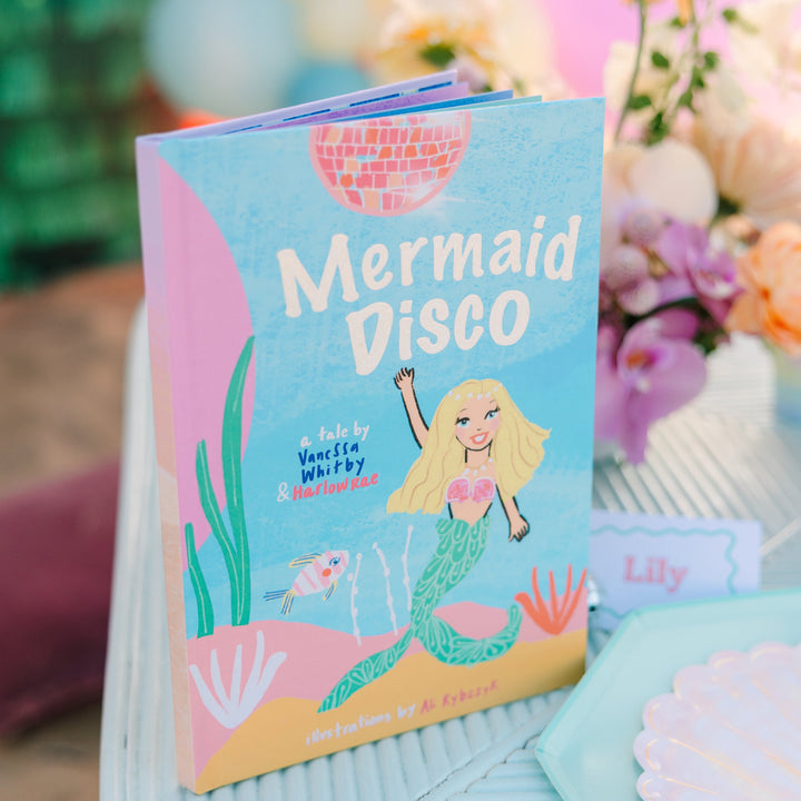 Children's book titled 'Mermaid Disco' with a mermaid illustration on a decorative surface.