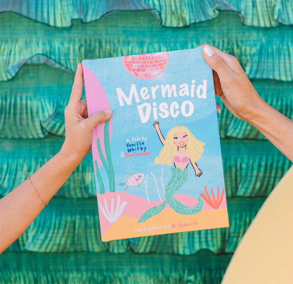 Book titled 'Mermaid Disco' held against a teal wave-patterned background